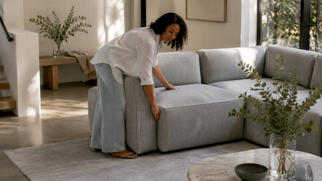 Woman arranging modular sofa units in living room