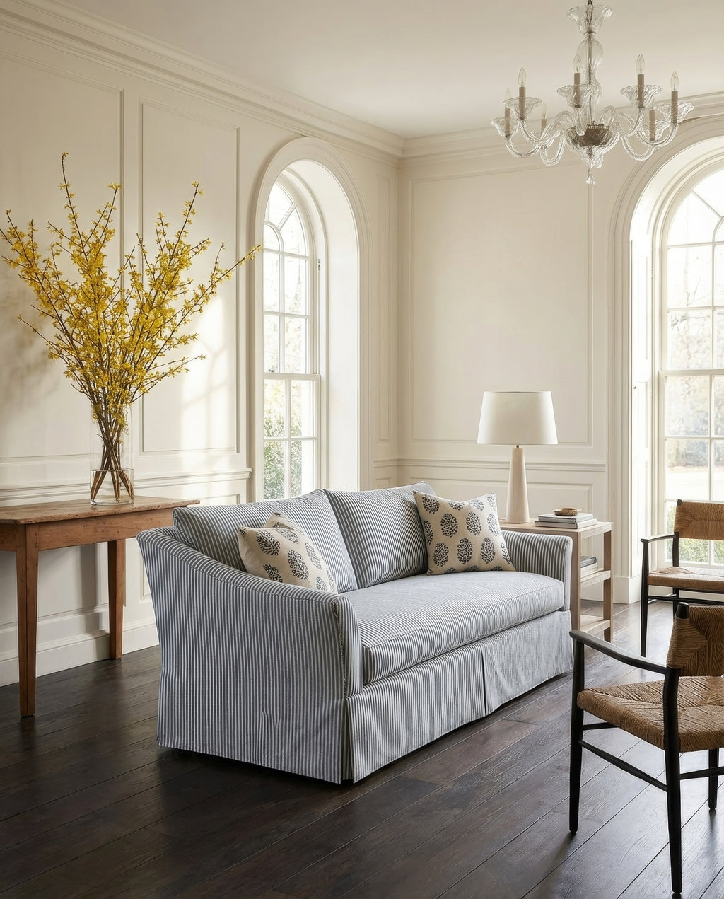 Living room with a striped sofa, wooden table, and decorative elements.